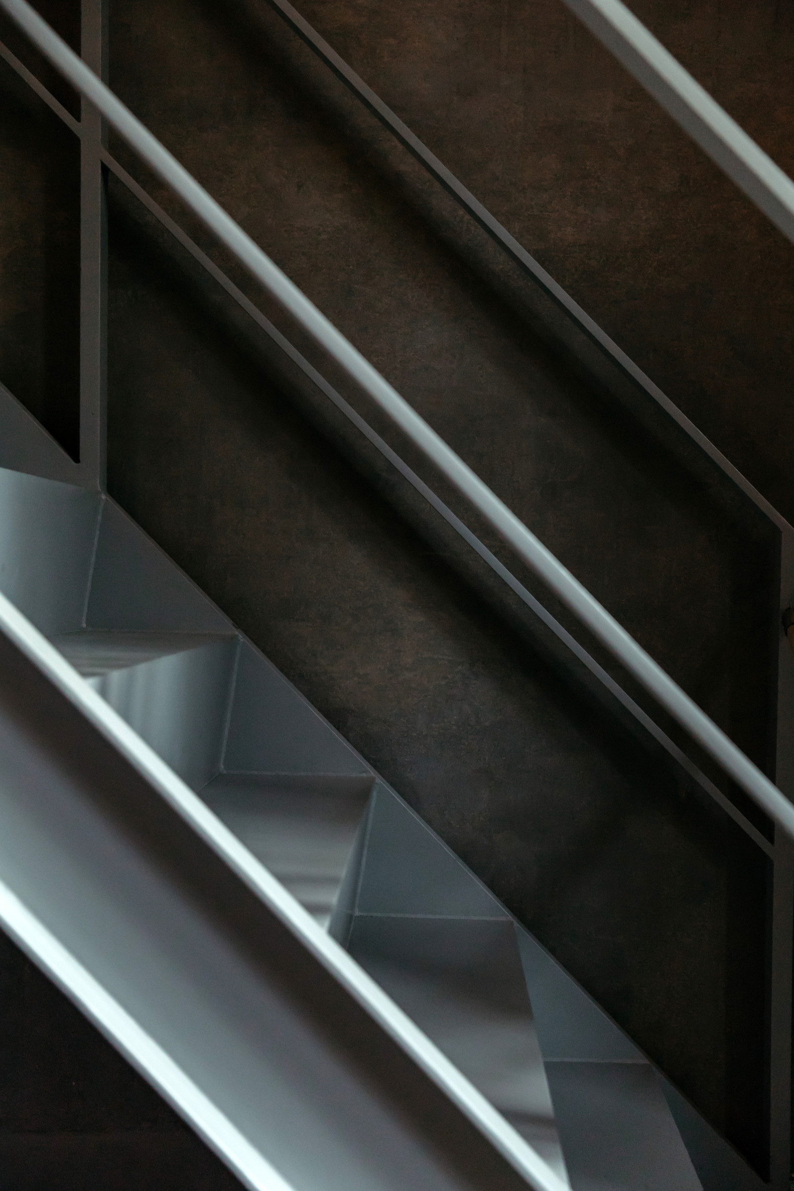 Light crossing the rails of a staircase